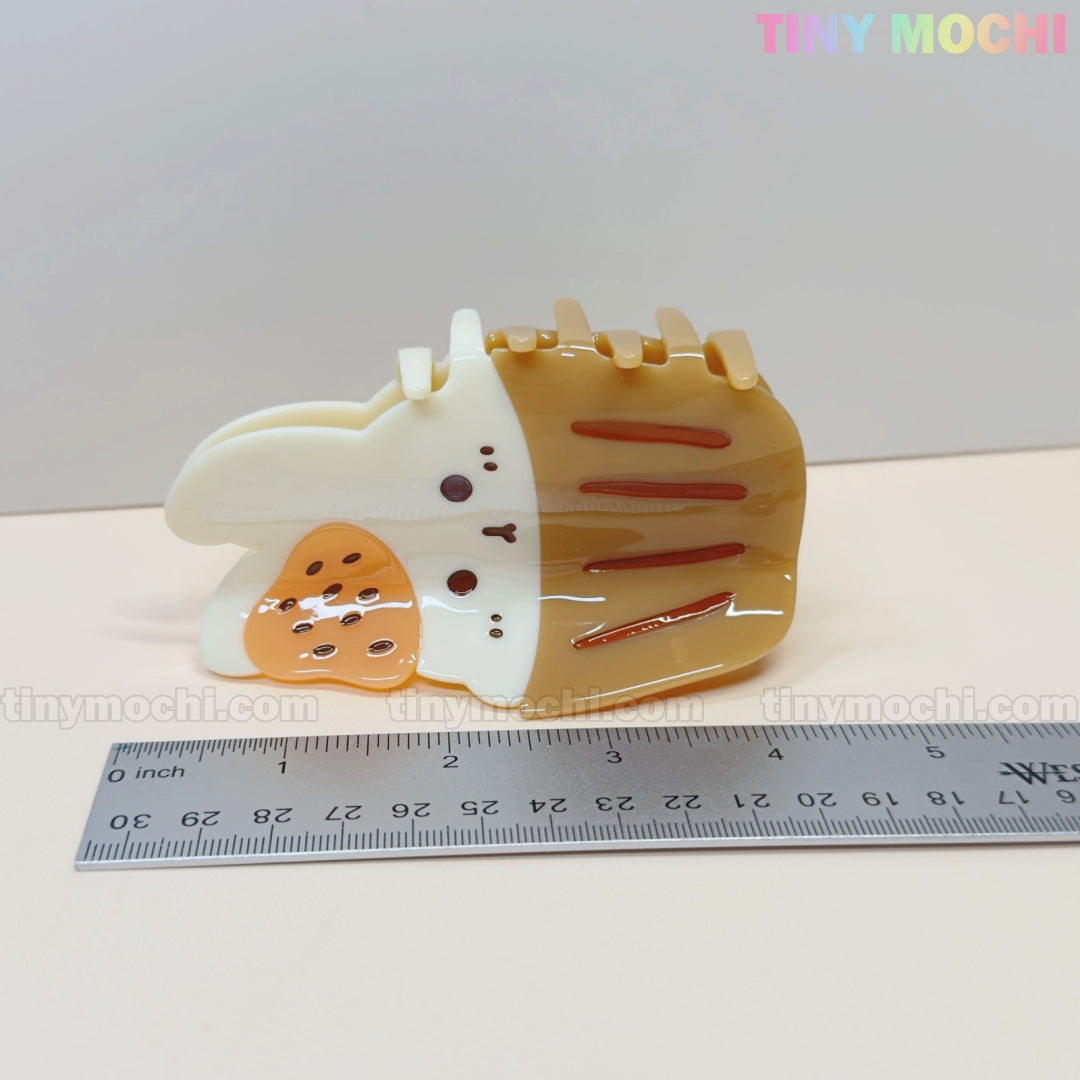 The Kawaii Cupcake Bunny Hair Claw Clip by Tiny Mochi is a cute acrylic accessory for women and girls, featuring a strawberry dessert style. Shown near a ruler on a light background with the tinymochi.com watermark and TINY MOCHI logo.
