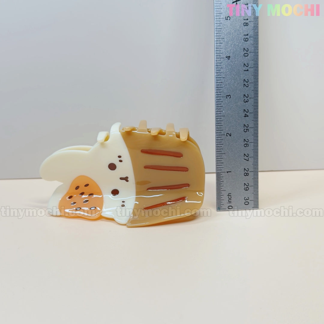 The Kawaii Cupcake Bunny Hair Claw Clip by Tiny Mochi, a cute strawberry dessert-style acrylic accessory for women and girls, is shown next to a vertical ruler for scale, measuring about 5 cm tall. The plain background features the Tiny Mochi watermark.