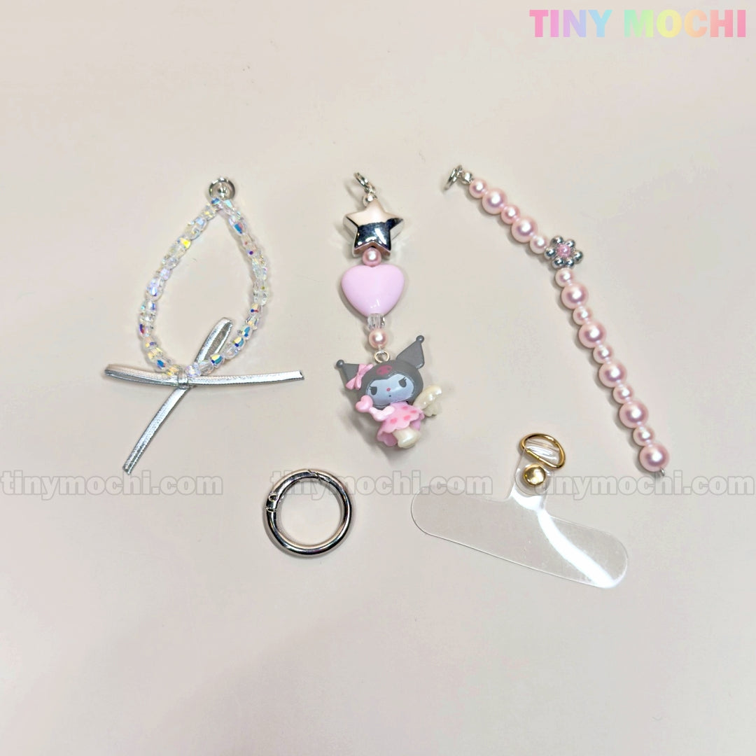 Five pastel accessories from the Tiny Mochi Kawaii Angel Charm Keychain Kit are displayed on a light background, featuring pearls, ribbon, star charms, and beads. The Tiny Mochi logo is shown in the top right corner.