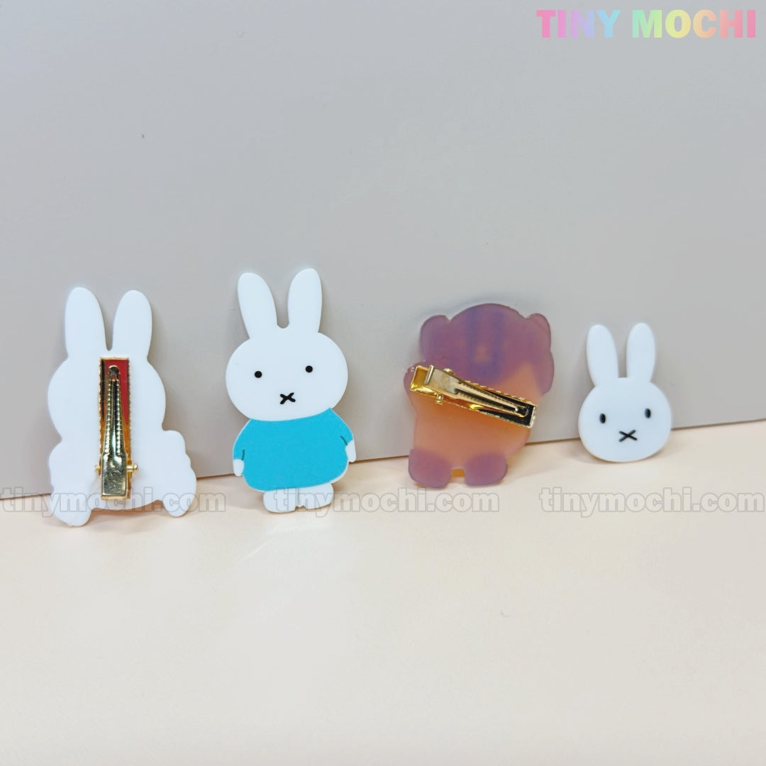 Four Kawaii Bunny & Bear Acrylic Hair Clips from Tiny Mochi are shown on a light surface, with pastel logo accents. Two display cute animal fronts and two show metal clasps, perfect cute hair accessories for girls and women.