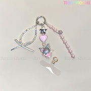The Kawaii Angel Charm Keychain Kit by Tiny Mochi features pink beads, a silver star, heart, gray character charm, clear strap and sequin loop for DIY phone or bag accessories. Displayed on a light surface with TINY MOCHI text in the corner.