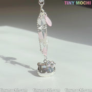 The Pink Kitty Phone Charm by Tiny Mochi features a silver Hello Kitty charm and pink and clear beads, embodying a kawaii Y2K coquette aesthetic with the pastel Tiny Mochi logo in the background.
