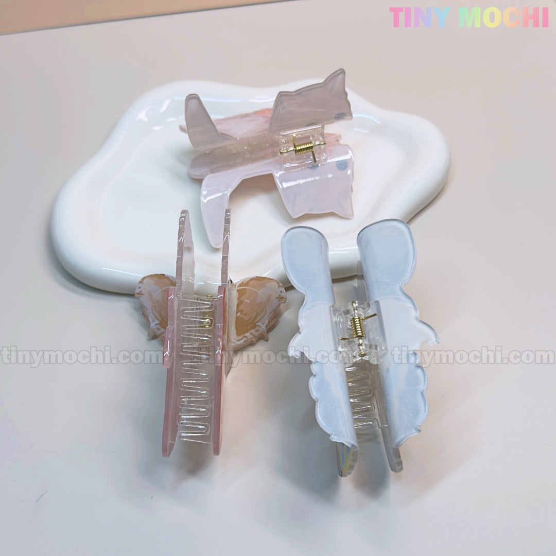 Three pastel Kawaii Dog & Cat Hair Claw Clips by Tiny Mochi are displayed on a white dish and surface, with the brand name in colorful letters at the top right. Ideal cute puppy and kitten accessories for girls who love playful pet-themed styles.