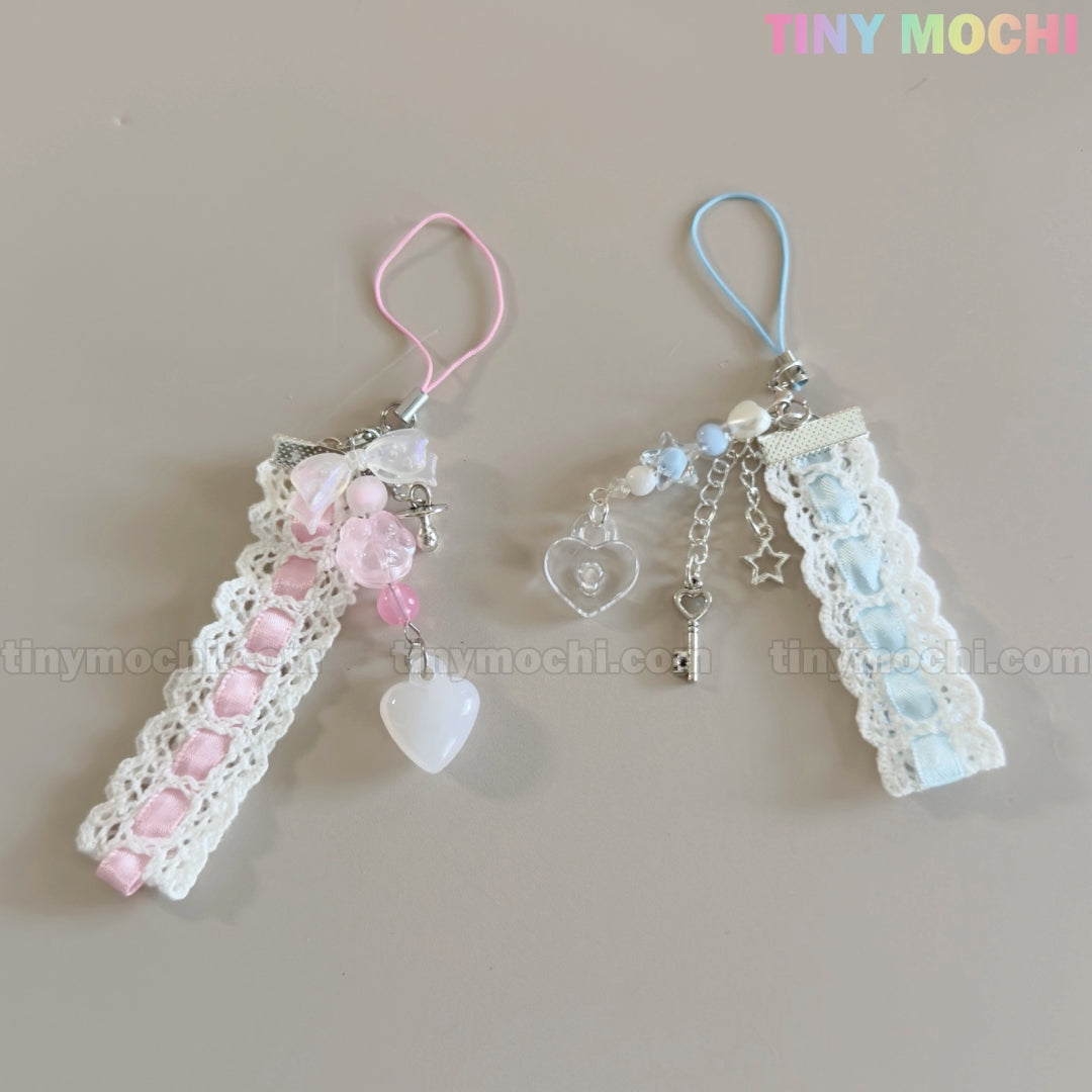 Set of two Tiny Mochi Kawaii Pastel Lace Ribbon Keychains—one pink with heart and bead charms, one blue with star, heart, and key charms. Cute fairycore bag charm accessories—perfect for adding a touch of whimsy!.