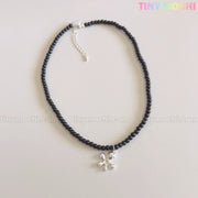 The Tiny Mochi Black Beaded Flower Necklace with Silver Floral Charm is a handmade Y2K choker, shown on a light background. The pastel Tiny Mochi logo appears in the top right corner. Perfect statement jewelry for her with soft grunge style.