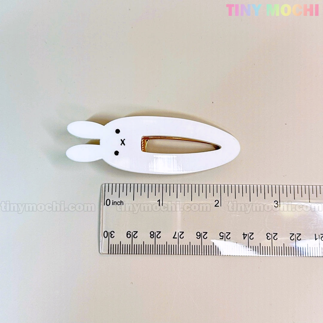 A white bunny-shaped hair clip with two ears and a cute face, about 2 inches long, from Tiny Mochis Kawaii Bunny and Bear Hair Clips for Girls—perfect for fans of adorable cartoon animal snap & alligator clips.