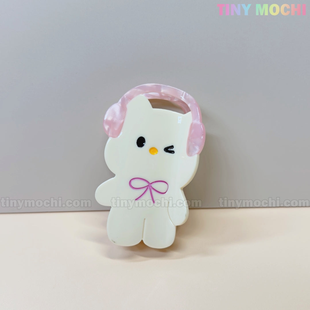 A cute cartoon bunny and bear hair claw clip set featuring pink headphones is displayed against a plain background—an adorable kawaii accessory. The words Tiny Mochi appear in the top right corner.