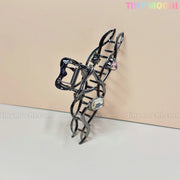 The Dark Silver Crystal Heart Hair Claw by Tiny Mochi is an elegant cat-shaped metal hair clip with curled tail, pink and clear gemstones, and sparkling crystal hearts. Displayed on a light beige background with TINYMochi.com watermarks.