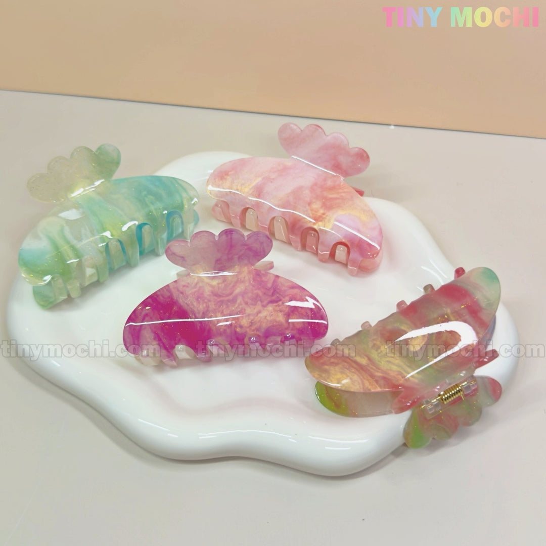 Tiny Mochis Pastel Hair Claw Clip set features UV-reactive, color-changing acetate clips in green, pink, purple, and blue—fairycore hair accessories for women and girls displayed on a glossy white cloud tray.