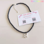 The Black Beaded Flower Necklace with Silver Floral Charm by Tiny Mochi, a handmade Y2K choker with a soft grunge aesthetic, is shown with a branded card featuring Etsy and Instagram QR codes against a light background.