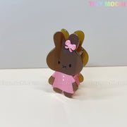 The Kawaii Bunny Hair Claw Clip by Tiny Mochi features a cute pastel acrylic bunny in a dress with a bow, standing upright on a light surface. The brand name appears in pastel colors in the top right corner.