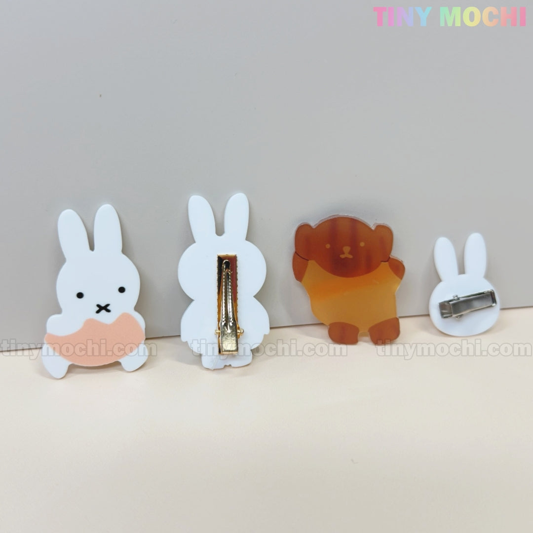Four Kawaii Bunny & Bear Acrylic Hair Clips by Tiny Mochi—featuring two white bunnies, a brown bear, and a small white bunny—are neatly arranged on a light surface. TINY MOCHI is displayed in the top right corner.
