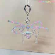 The Cotton Candy Wings Charm Keychain by Tiny Mochi features pastel pink, blue, and purple wings, a cute white character with a pink heart, and beaded bow details—perfect as a kawaii fairycore phone charm or gift accessory.