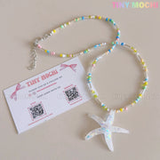 The Tiny Mochi Pastel Starfish Beach Bead Necklace features a handmade iridescent resin starfish pendant and pastel beads—a kawaii oceancore choker, perfect summer jewelry for girls and teens.
