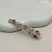 The Tiny Mochi Kawaii Gem Hair Clips for Girls feature silver pins adorned with alternating pink rhinestones and small silver hearts—perfect sparkle for Y2K lovers and Coquette aesthetic fans. Product shown on a white ceramic dish with the tinymochi.com watermark.