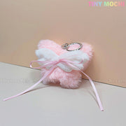 Add a coquette-inspired touch to your accessories with the Tiny Mochi Plush Butterfly Bow Keychain—a pink fuzzy bag charm featuring a cute ribbon bow, perfect for soft girl style or as a kawaii gift. Brand logo shown on a pastel background.