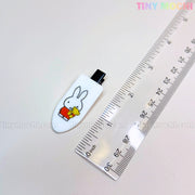 A Tiny Mochi Kawaii Bunny Hair Clip—cute resin alligator clip from the girls’ barrette gift set—is shown beside a clear centimeter ruler, styled on a light background for fans of playful bunny accessories.