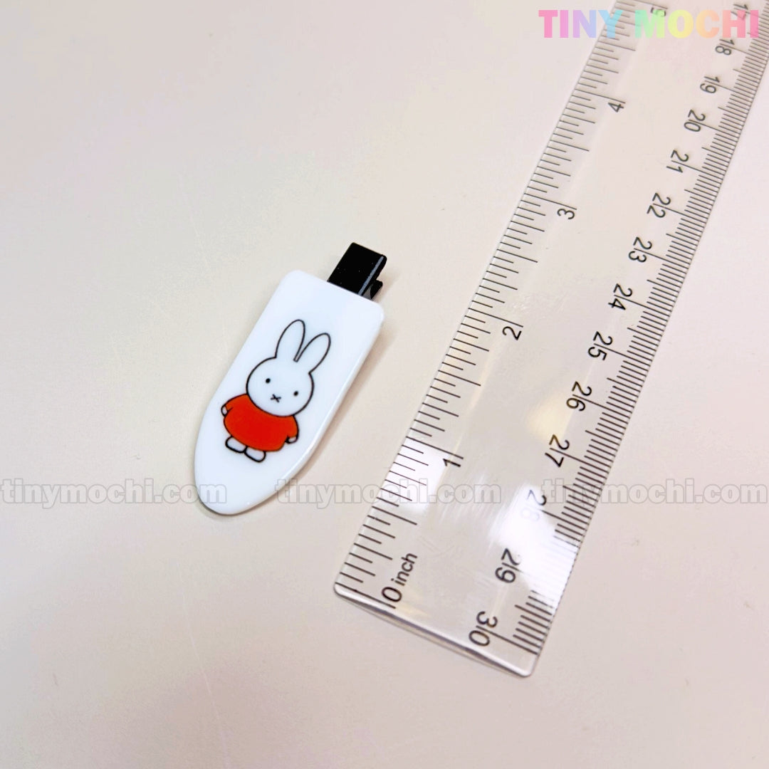 A Tiny Mochi Kawaii Bunny Hair Clip for Girls, featuring a cute bunny in red, sits beside a clear ruler showing this colorful cartoon resin barrette is about 5 cm long—perfect as a playful hair accessory gift set for kids.