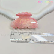 The Tiny Mochi Pastel Hair Claw Clip, a color-changing UV-reactive acetate accessory for women & girls, is shown on a white surface beside a clear cm ruler, with scalloped edging and the pastel Tiny Mochi logo in the top right.