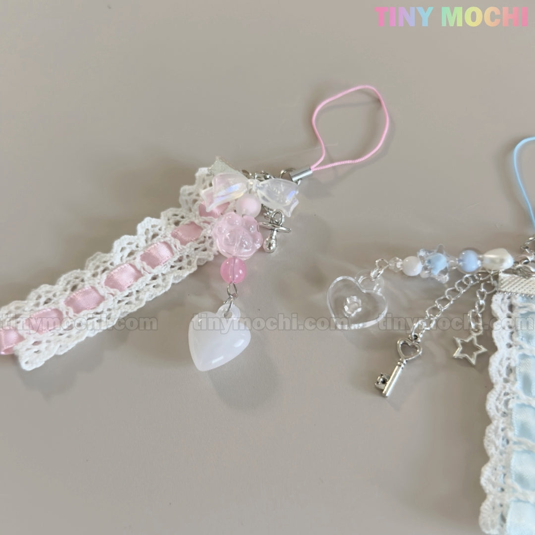 Two Kawaii Pastel Lace Ribbon Keychains by Tiny Mochi—one with pink accents and a heart, the other with blue-white beads, heart, key, and star charms. Perfect Fairycore accessories; shown on a light surface with TINY MOCHI in the corner.
