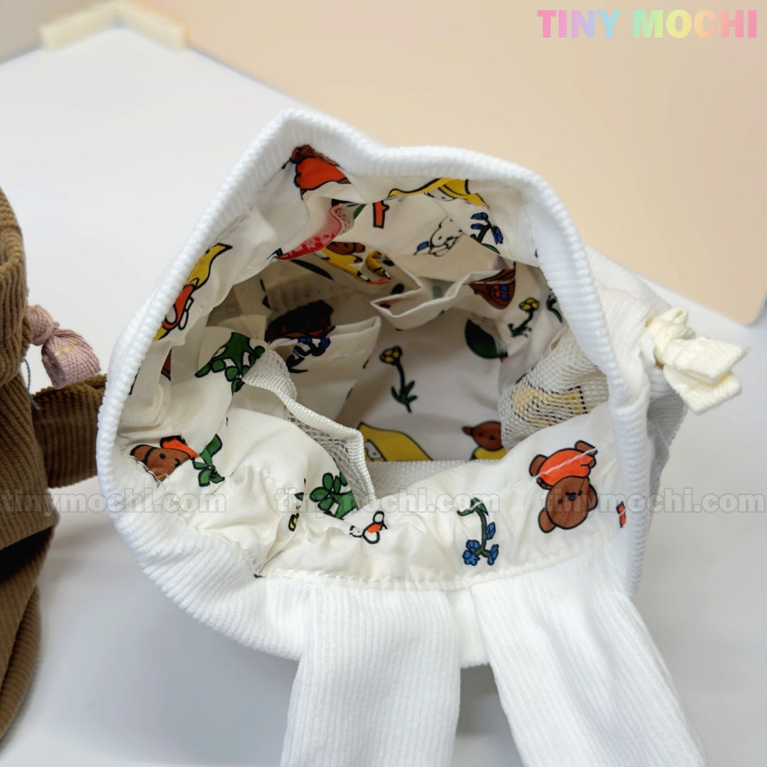 The Kawaii Bunny & Bear Drawstring Pouch from My Store is a white corduroy coin makeup bag with an open top, lined with cute animal and plant prints. The words TINY MOCHI appear in pastel colors in the upper right corner.