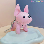 A pink French Bulldog Keychain Coin Purse by Tiny Mochi, featuring large ears and black button eyes, rests on a glossy white surface. “TINY MOCHI” appears in pastel at the top right—a cute faux leather dog bag charm gift for dog lovers.