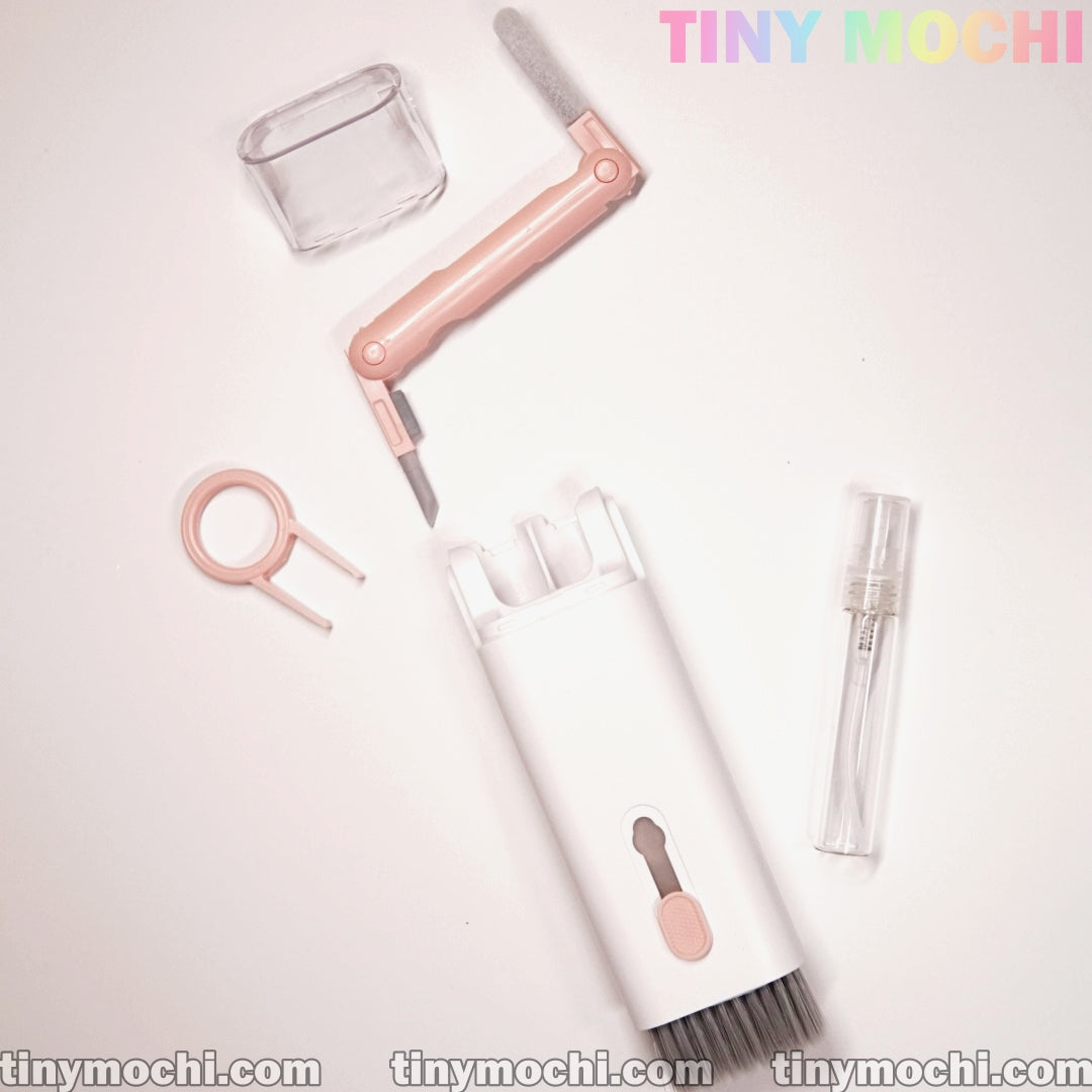 The Tiny Mochi 7 in 1 Multifunctional Electronic Cleaner Kit is a compact white set featuring a pink brush, screen cleaning spray bottle, keycap puller, protective cap, and pastel Tiny Mochi branding on a light background.