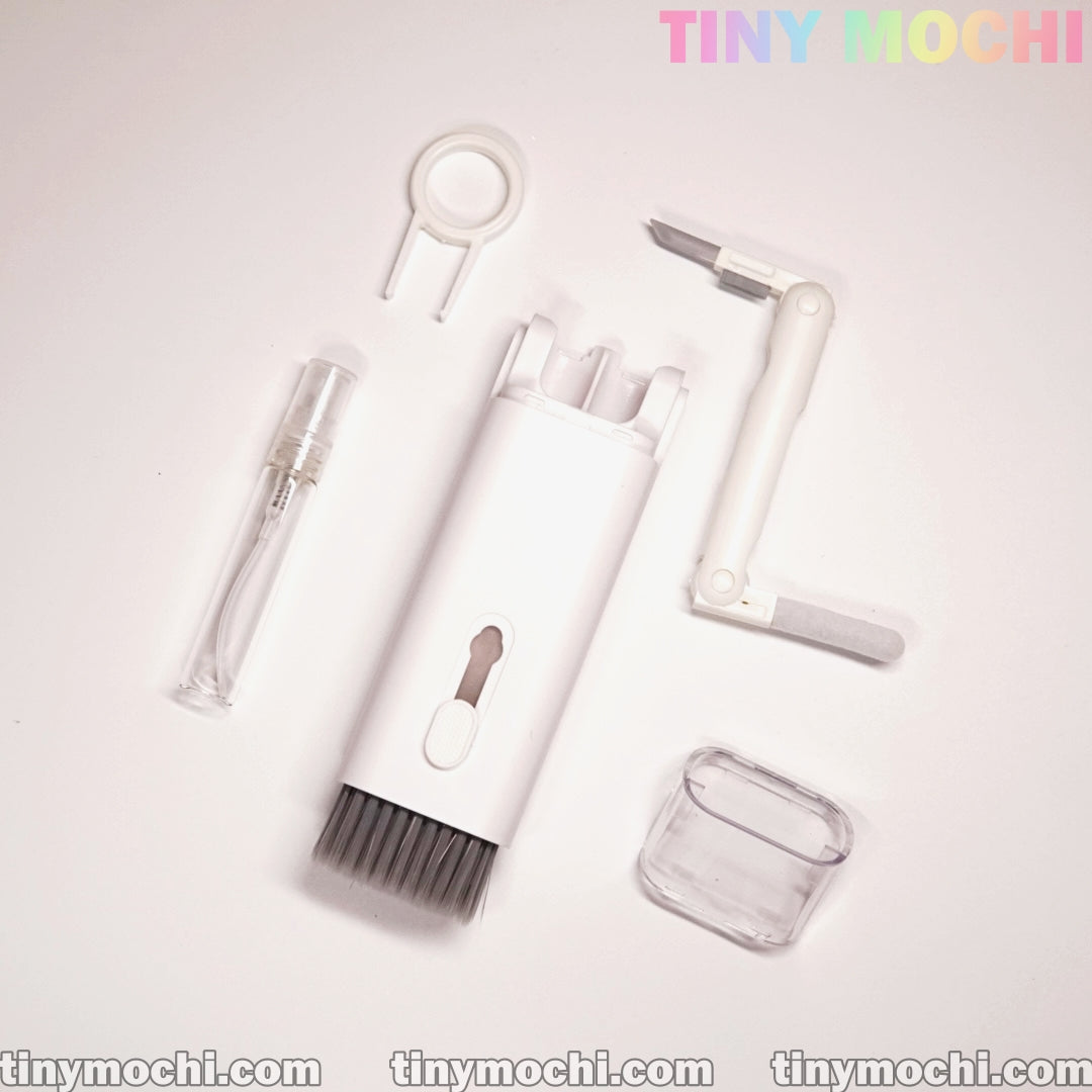 The Tiny Mochi 7 in 1 Multifunctional Electronic Cleaner Kit, featuring detachable accessories like a brush, nozzle, and clip, is displayed on a white background with tiny mochi in colorful text at the top right.