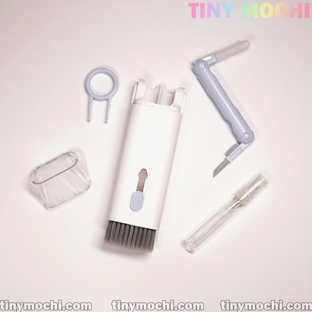 The Tiny Mochi 7 in 1 Multifunctional Electronic Cleaner Kit includes a brush, detachable cover, spray bottle for screen cleaner, keycap puller, and foldable tool—everything you need for electronic cleaning. Tiny Mochi appears at the top right.