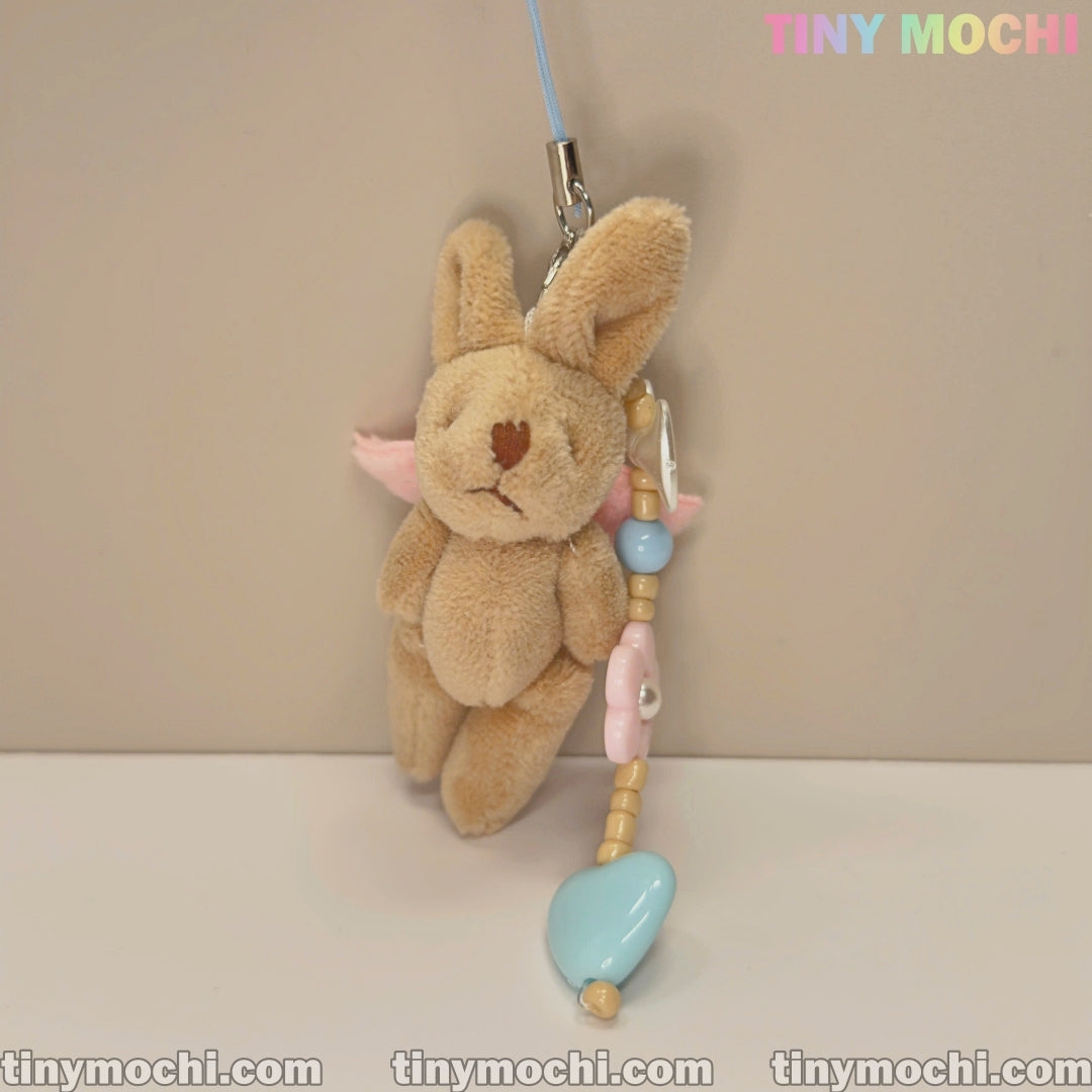 A Cute Pink Wings and Elegant Beige Soft Bunny Keychain with a large blue heart bead and flower beads in pastel shades is attached to a stylish beaded strap. Brand: Tiny Mochi. Ideal for mobiles, handbags, and more.
