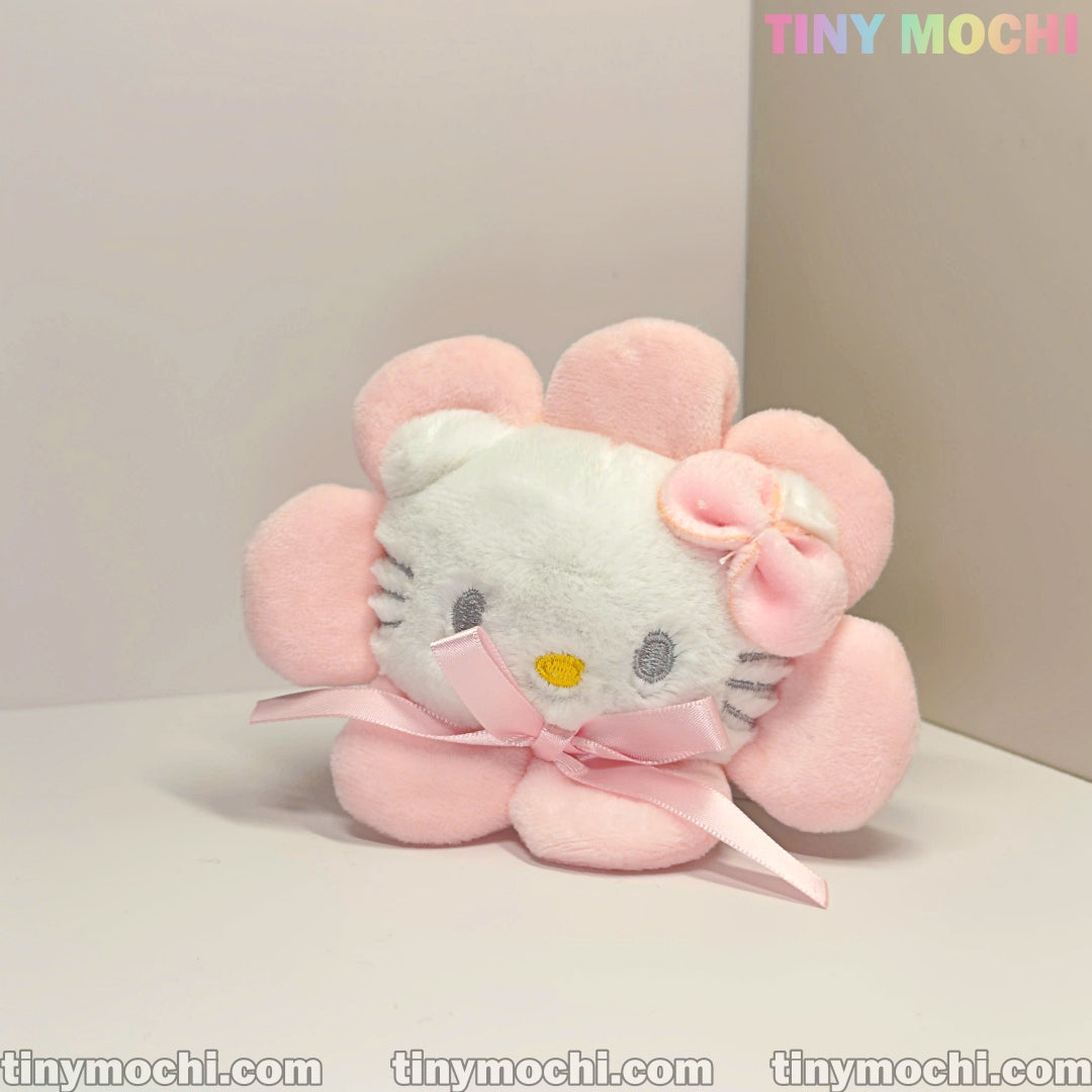 The Tiny Mochi Cute White Cat Kitty and Pinky Sunflower Plush Keychain, a soft stuffed cartoon toy with a pink bow and ribbon, is displayed against a light background. TINY MOCHI appears in the top right corner.