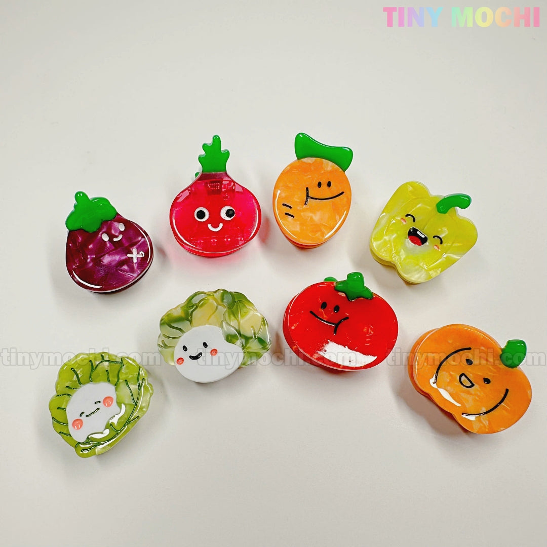 Eight adorable Kawaii Vegetable Hair Clips from Tiny Mochi Gift Shop Houston are arranged on a white background. This 8-piece set adds a cute, playful touch to your hair accessory collection. The Tiny Mochi logo is in the top right corner.