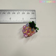 A small, shiny grape-shaped charm with gold outlines and green leaves sits by a ruler showing it's ~3 cm wide. "Fruity Friends Hair Clip Set" by Tiny Mochi Gift Shop Houston—ideal for kawaii hair accessories fans!.
